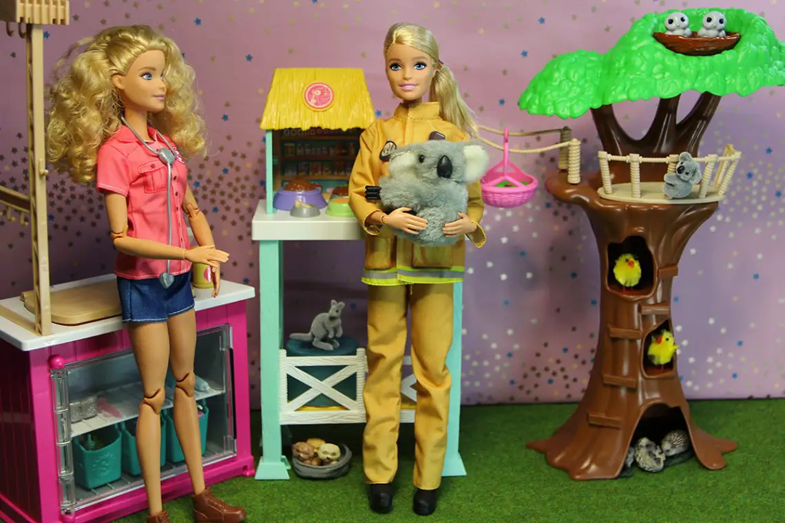 firefighter Barbie holding a koala in the animal rescue playset
