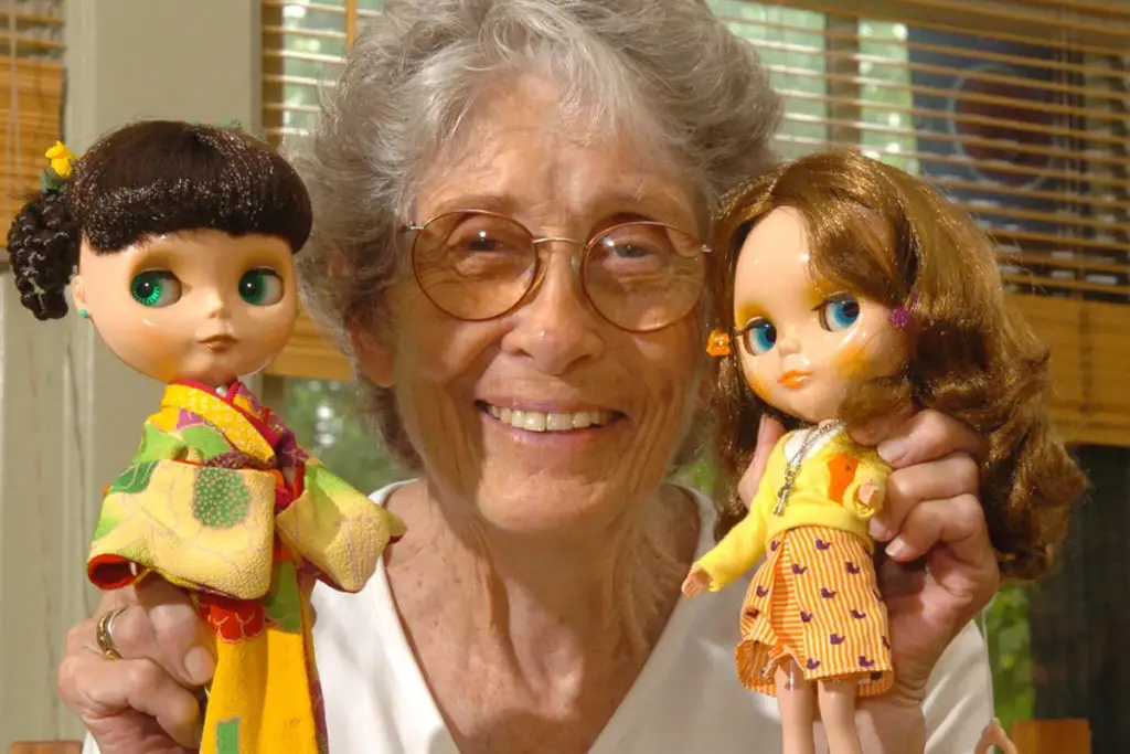 Allison Katzman, original Blythe doll designer, holding two Neo Blythes